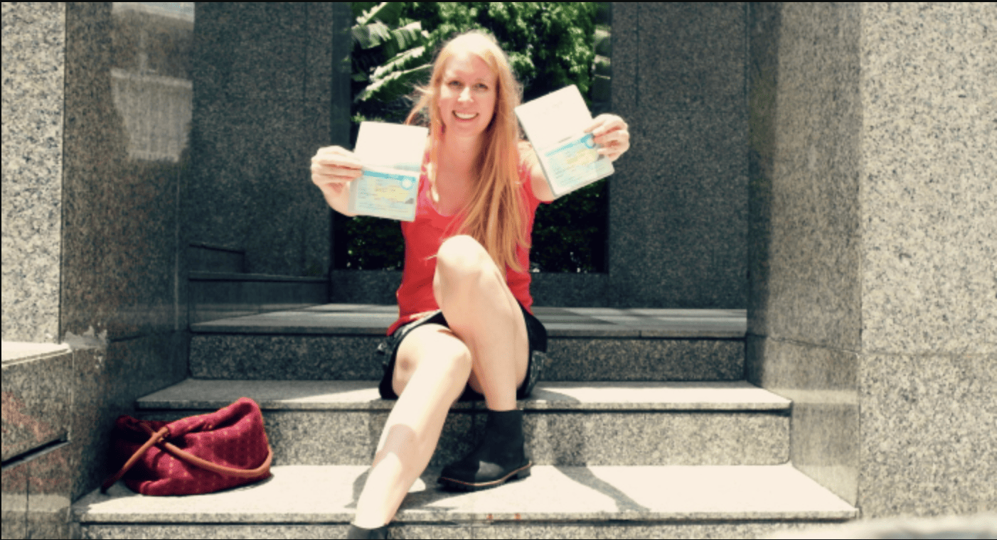girl holding up two passports