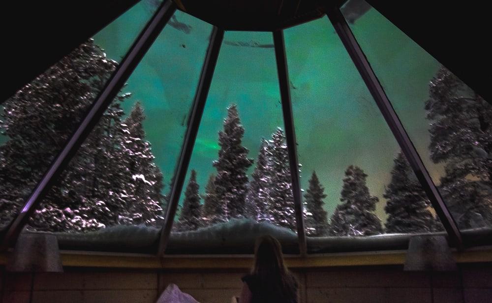 seeing northern lights from glass igloo cabin finland