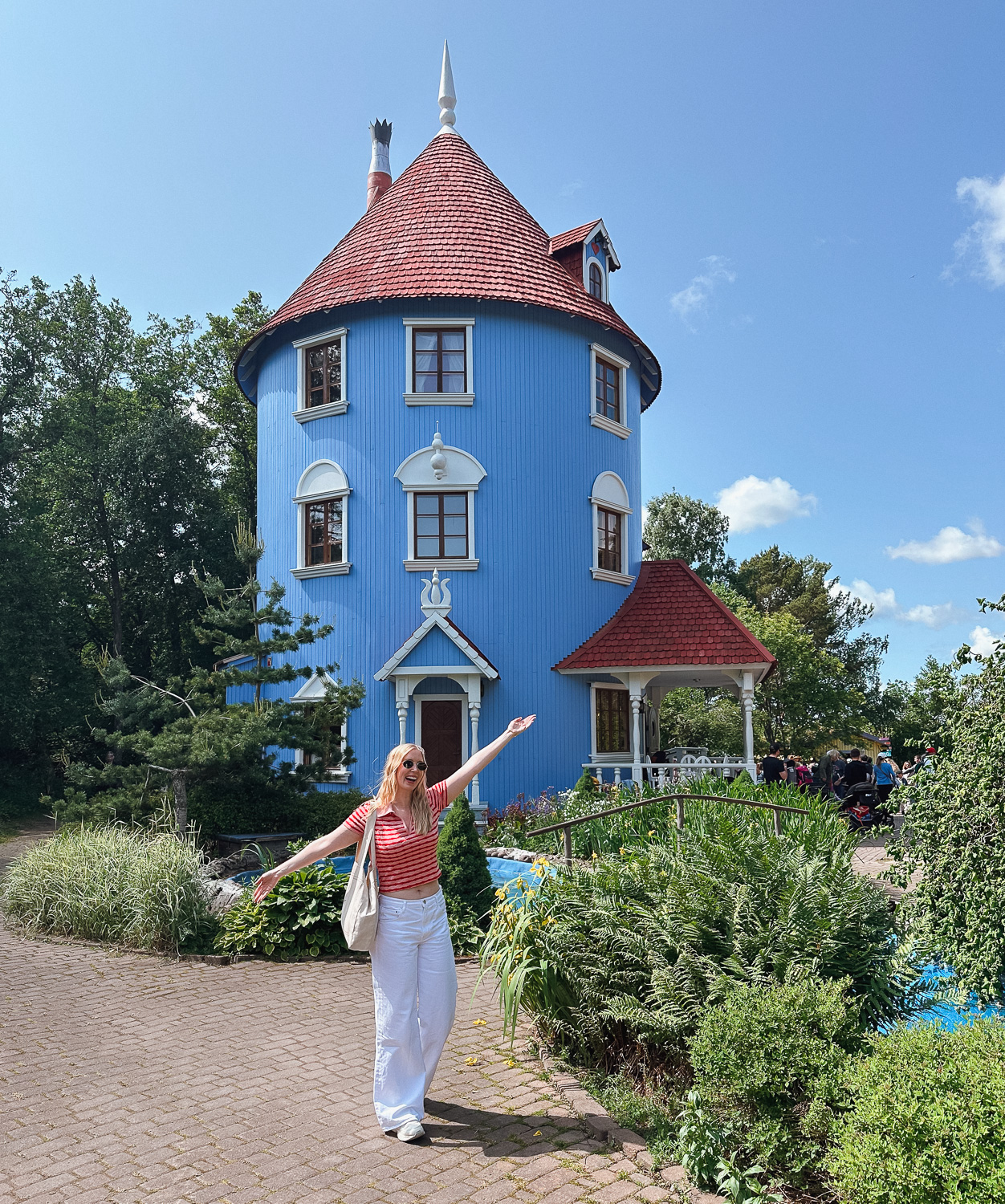 standing in front of Moominhouse in Moomin World Naantali, Finland