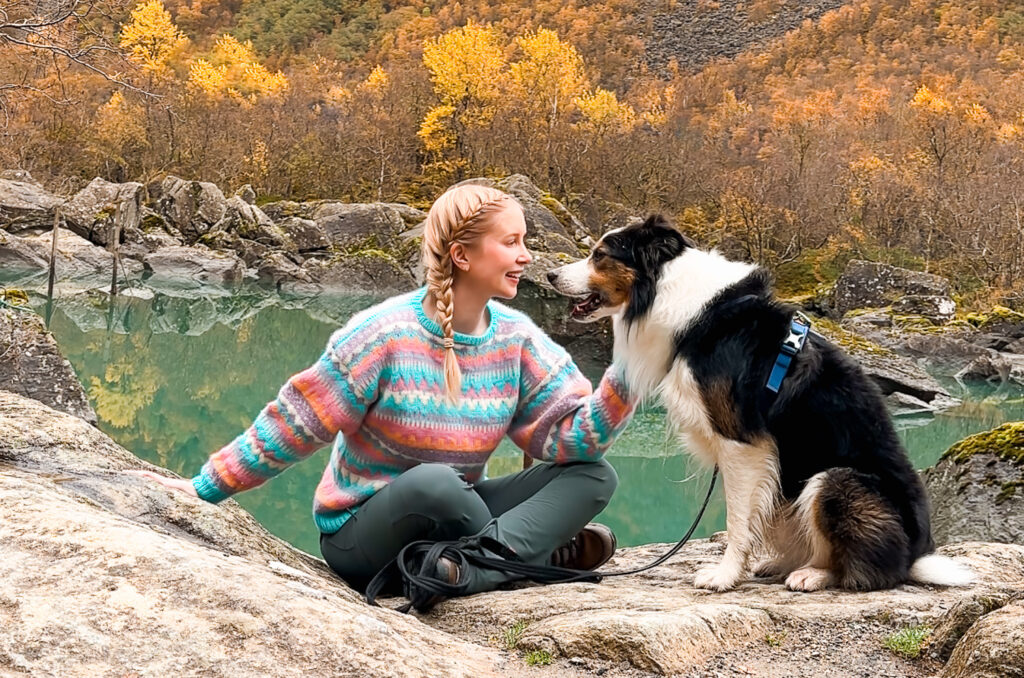 woman wearing une sweater and her dog in Norway